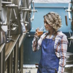 Brauerin testet frisch gebrautes Bier in Brauerei.